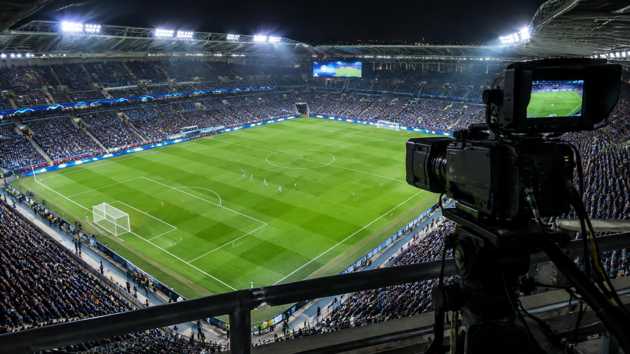 Floodlit football stadium seen from a camera gantry